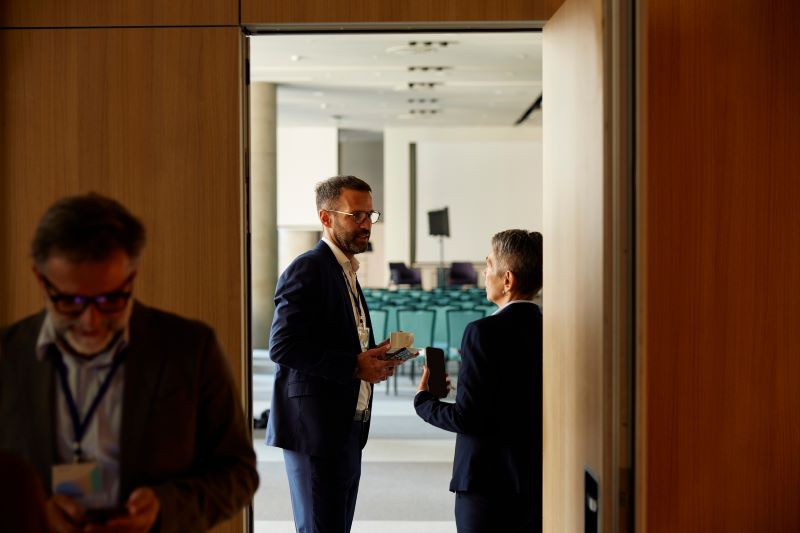Two colleagues talking in front of the door
